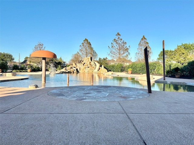 view of swimming pool featuring a water view