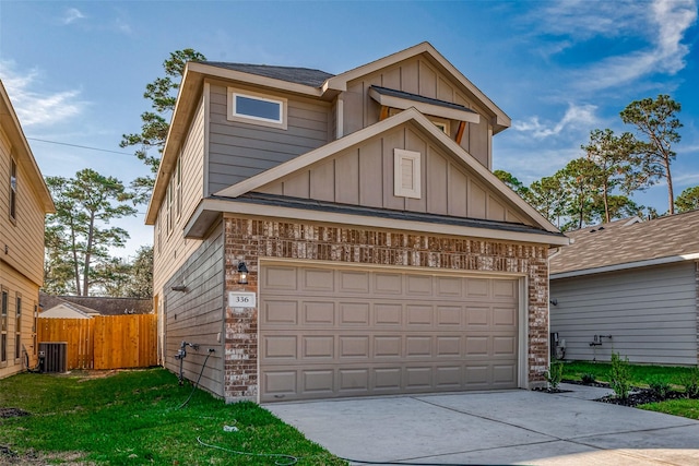 view of front of house with a front yard, central AC, and a garage