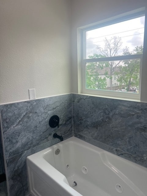 full bath featuring a tub with jets