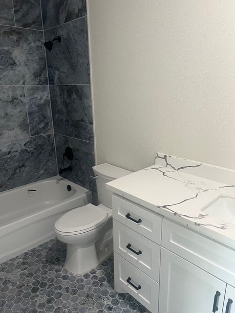 bathroom featuring vanity, washtub / shower combination, and toilet