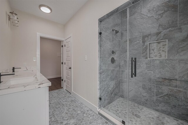 2206 Hoskins Dr, Houston, TX 77080 - bathroom featuring a stall shower, baseboards, and double vanity