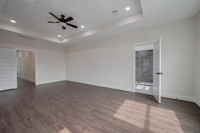 2206 Hoskins Dr, Houston, TX 77080 - unfurnished room featuring ceiling fan, a tray ceiling, baseboards, dark wood-type flooring, and a textured ceiling