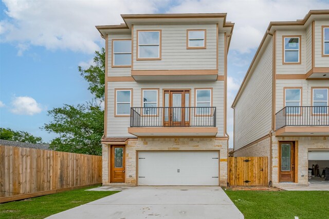 2206 Hoskins Dr, Houston, TX 77080 - view of front of house with stone siding, concrete driveway, and an attached garage