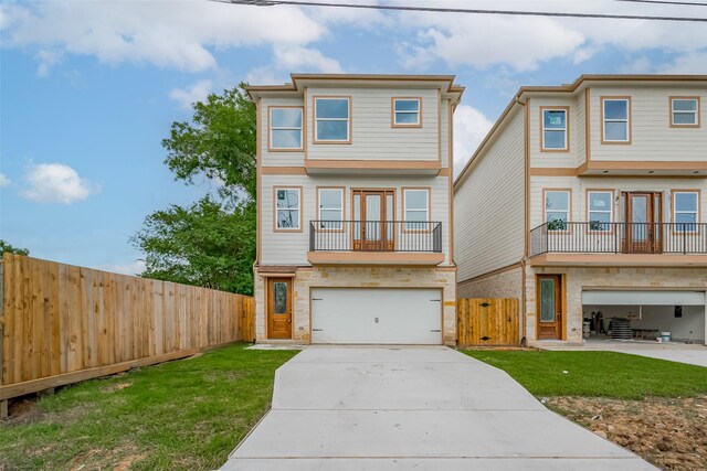 2206 Hoskins Dr, Houston, TX 77080 - view of front of house featuring a garage, a balcony, driveway, and a gate