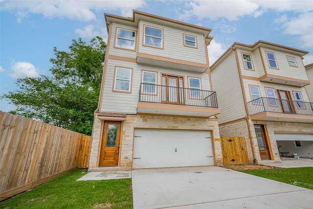 2206 Hoskins Dr, Houston, TX 77080 - view of property with an attached garage, driveway, stone siding, a balcony, and a gate
