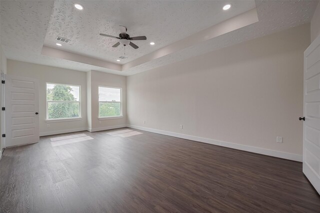 2206 Hoskins Dr, Houston, TX 77080 - spare room with a tray ceiling, dark wood finished floors, baseboards, ceiling fan, and a textured ceiling