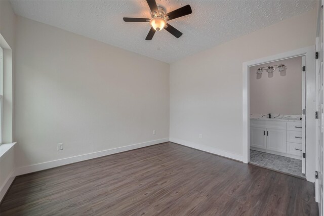 2206 Hoskins Dr, Houston, TX 77080 - unfurnished room with dark wood-type flooring, a textured ceiling, a ceiling fan, and baseboards