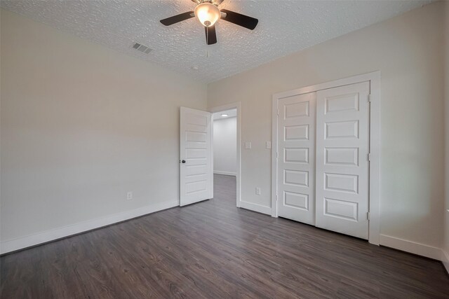 2206 Hoskins Dr, Houston, TX 77080 - unfurnished bedroom featuring dark wood finished floors, baseboards, a textured ceiling, a closet, and a ceiling fan