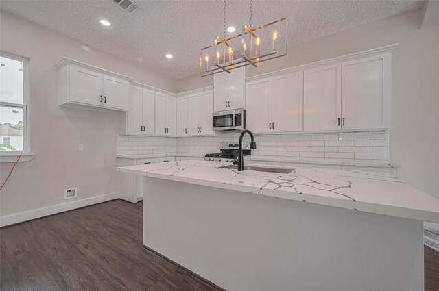 2206 Hoskins Dr, Houston, TX 77080 - kitchen featuring stainless steel appliances, white cabinetry, dark wood-type flooring, a sink, and tasteful backsplash