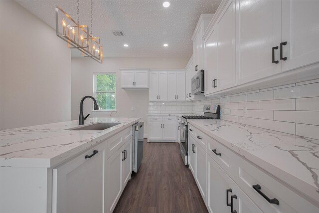 2206 Hoskins Dr, Houston, TX 77080 - kitchen with stainless steel appliances, a sink, white cabinetry, dark wood-style flooring, and recessed lighting