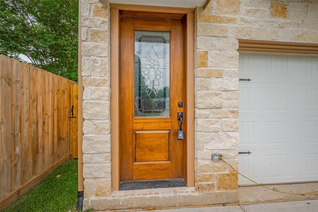 2206 Hoskins Dr, Houston, TX 77080 - doorway to property featuring stone siding and a garage