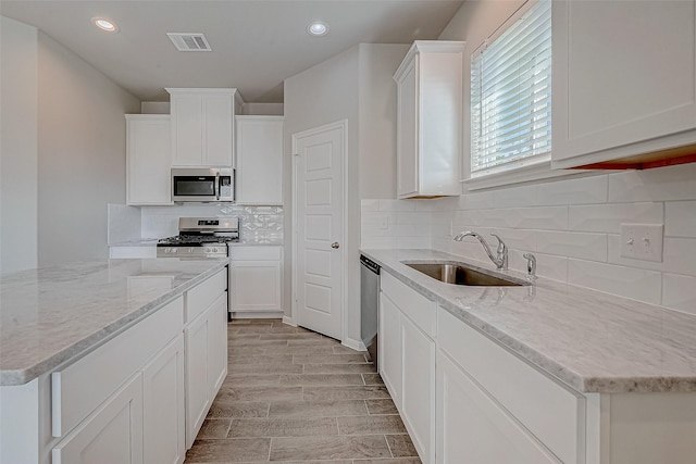 kitchen featuring white cabinets, sink, and stainless steel appliances