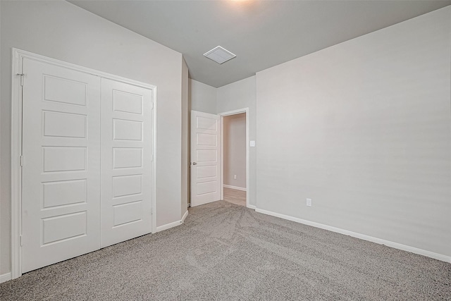 unfurnished bedroom featuring carpet flooring and a closet