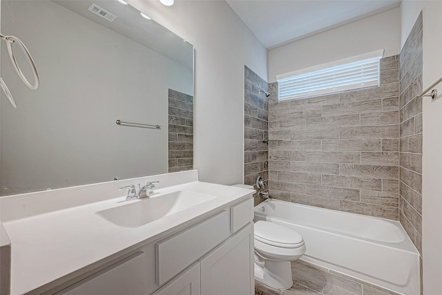 full bathroom with tile patterned flooring, vanity, toilet, and tiled shower / bath