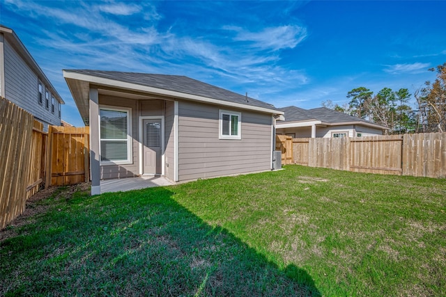 rear view of property with a lawn