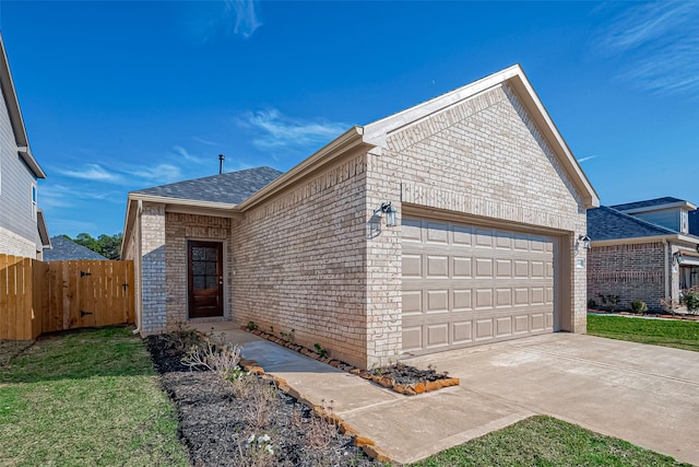 view of front of property featuring a garage and a front lawn