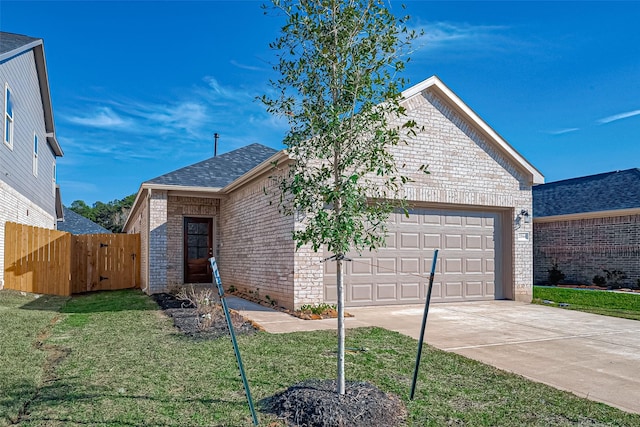 view of front of house featuring a front yard and a garage