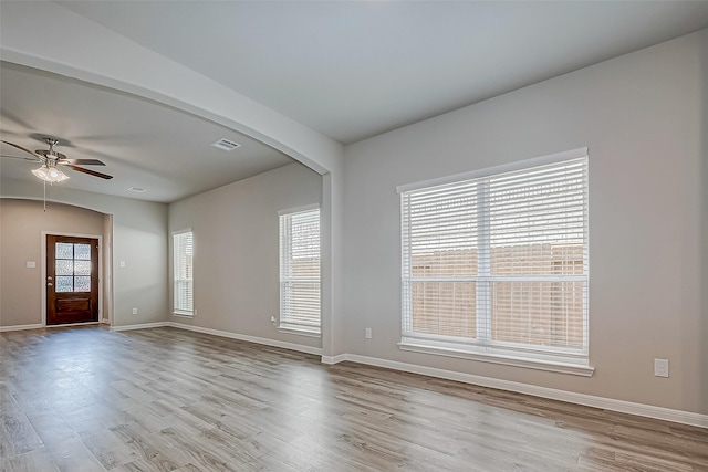 unfurnished room with light wood-type flooring and ceiling fan