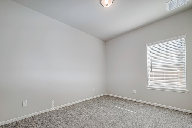 carpeted spare room featuring a wealth of natural light