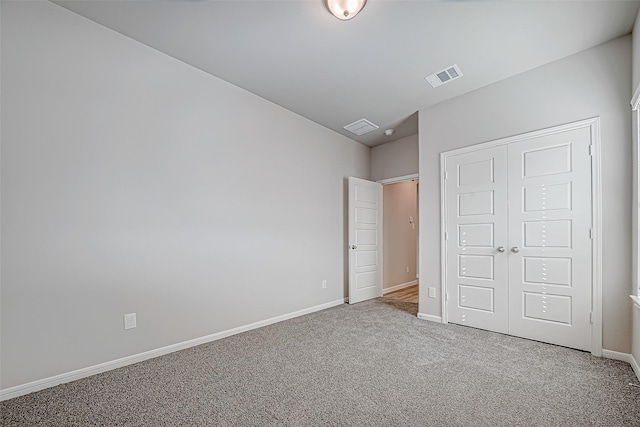 unfurnished bedroom featuring carpet floors and a closet