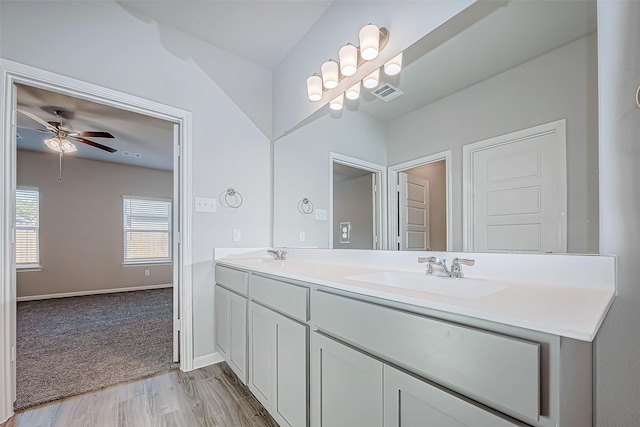 bathroom featuring wood-type flooring, vanity, and ceiling fan