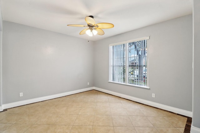 empty room featuring ceiling fan and light tile patterned flooring