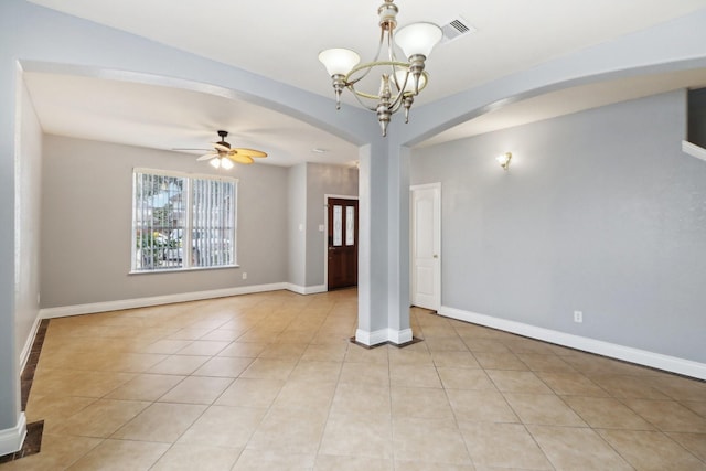 unfurnished room featuring ceiling fan with notable chandelier and light tile patterned floors