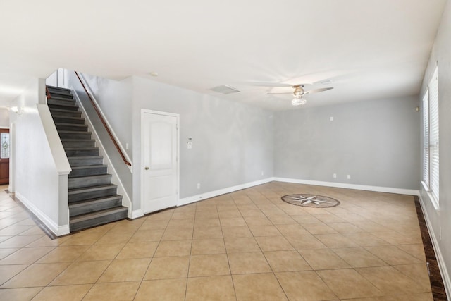 unfurnished room with light tile patterned floors and ceiling fan