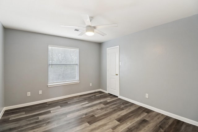 spare room featuring ceiling fan and dark wood-type flooring