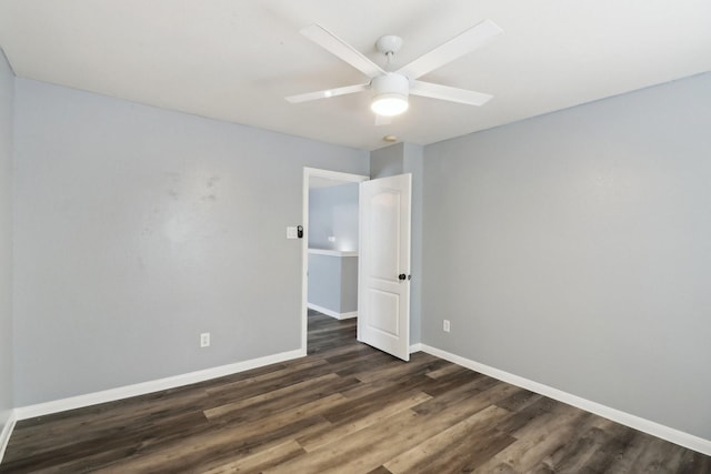 empty room featuring ceiling fan and dark wood-type flooring