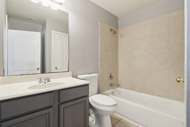 full bathroom with toilet, vanity, tiled shower / bath combo, and tile patterned floors