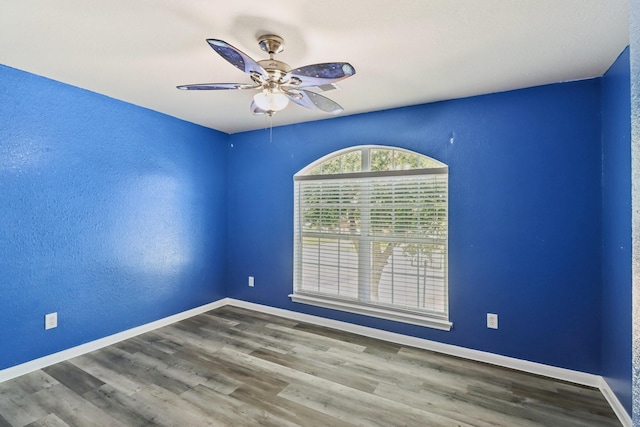 unfurnished room featuring ceiling fan and wood-type flooring