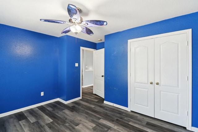 unfurnished bedroom with ceiling fan, a closet, and dark hardwood / wood-style floors