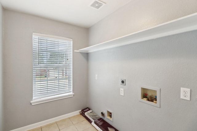 laundry room featuring hookup for an electric dryer, light tile patterned floors, and washer hookup