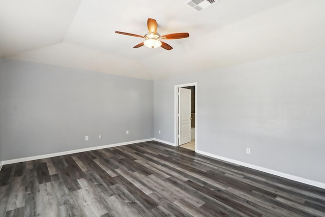 empty room with dark hardwood / wood-style floors, ceiling fan, and vaulted ceiling