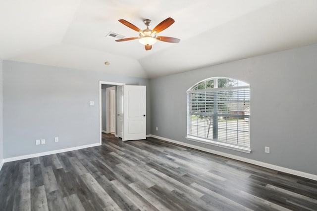 unfurnished room featuring dark hardwood / wood-style flooring, vaulted ceiling, and ceiling fan