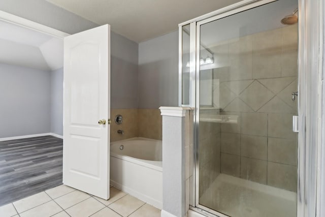 bathroom featuring tile patterned floors and independent shower and bath