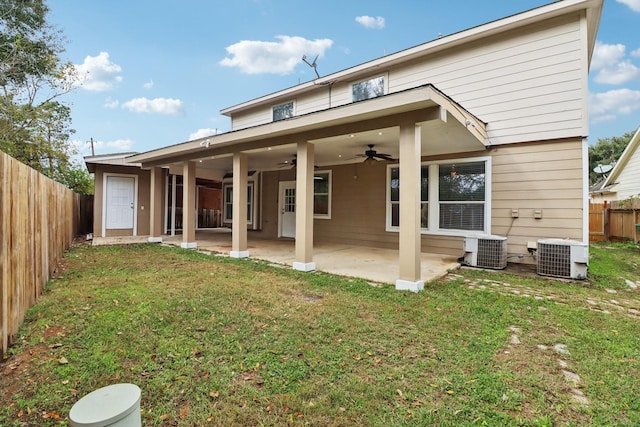 rear view of property with central air condition unit, a patio area, ceiling fan, and a lawn