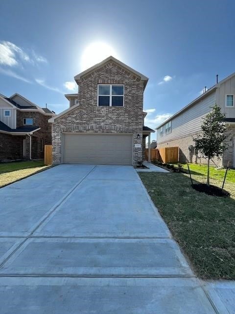 view of front property featuring a front lawn and a garage