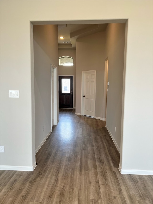 entryway with a high ceiling and dark hardwood / wood-style floors