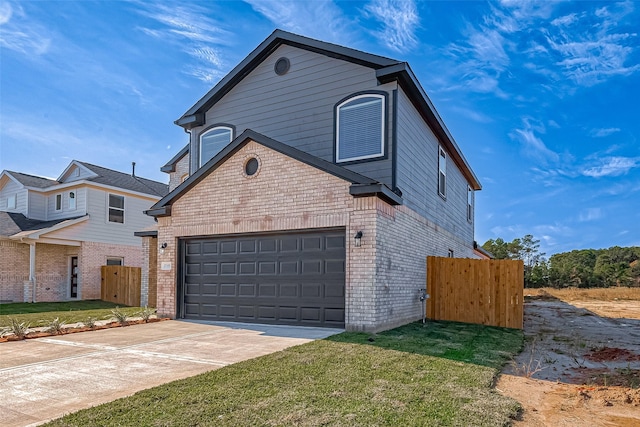 view of property with a garage and a front yard