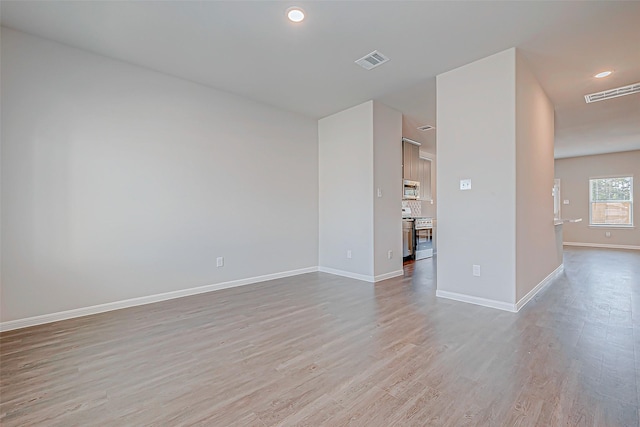 empty room with light hardwood / wood-style flooring