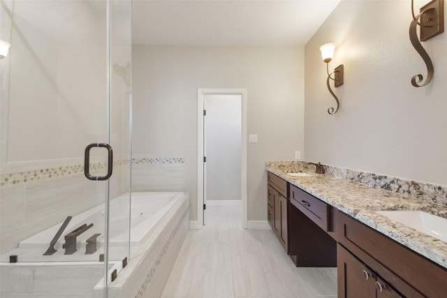 bathroom featuring separate shower and tub and vanity