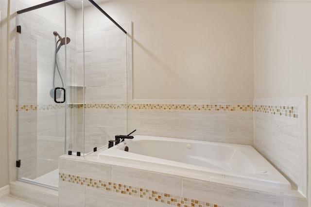 bathroom featuring separate shower and tub