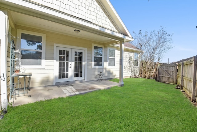 rear view of house with french doors, a yard, and a patio