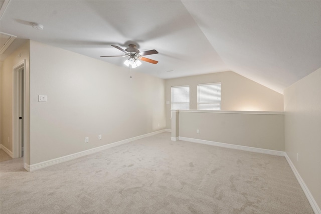 additional living space featuring light colored carpet, vaulted ceiling, and ceiling fan