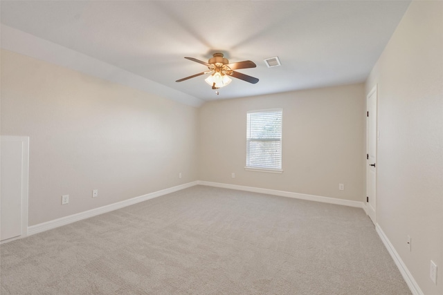 unfurnished room featuring ceiling fan, light colored carpet, and lofted ceiling