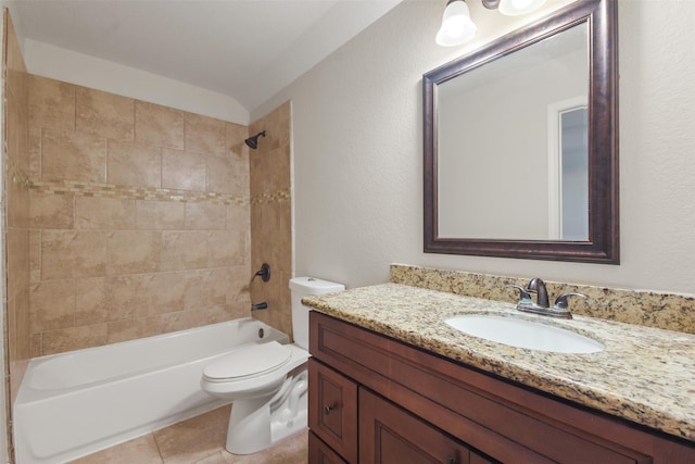 full bathroom featuring tile patterned flooring, vanity, tiled shower / bath combo, and toilet