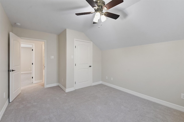 bonus room featuring ceiling fan, light carpet, and vaulted ceiling