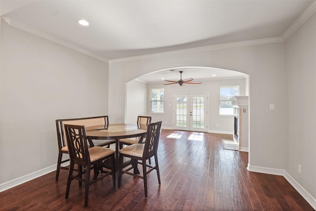 dining room with french doors, dark hardwood / wood-style flooring, ceiling fan, and crown molding